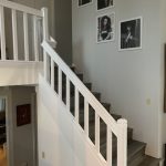 Painted white interior wall by staircase